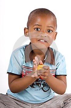 Three year old black boy playing with blocks