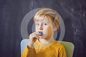 Three-year old boy shows myofunctional trainer. Helps equalize the growing teeth and correct bite, develop mouth