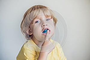 Three-year old boy shows myofunctional trainer to illuminate mouth breathing habit. Helps equalize the growing teeth and correct photo