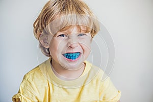 Three-year old boy shows myofunctional trainer to illuminate mouth breathing habit. Helps equalize the growing teeth and correct