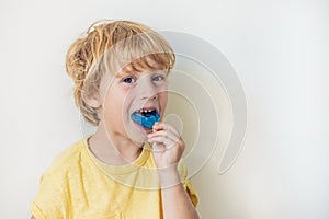 Three-year old boy shows myofunctional trainer to illuminate mouth breathing habit. Helps equalize the growing teeth and correct