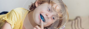 Three-year old boy shows myofunctional trainer to illuminate mouth breathing habit. Helps equalize the growing teeth and correct b photo