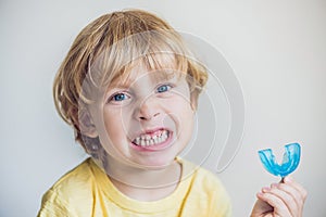 Three-year old boy shows myofunctional trainer to illuminate mouth breathing habit. Helps equalize the growing teeth and correct