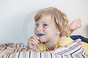 Three-year old boy shows myofunctional trainer to illuminate mouth breathing habit. Helps equalize the growing teeth and correct