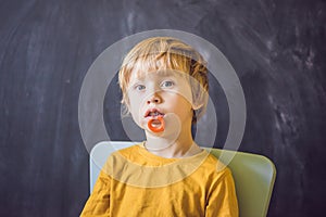 Three-year old boy shows vestibular plate. Plate with a bead to