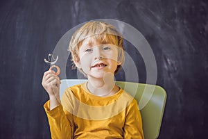 Three-year old boy shows vestibular plate. Plate with a bead to stimulate the tongue. dysarthria, rhinolalia photo