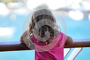 three-year-old girl admires the view of the Cyclades from the ferry