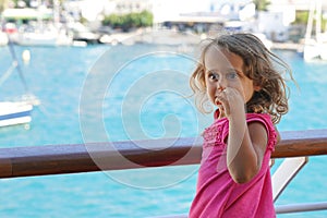 three-year-old girl admires the view of the Cyclades from the ferry