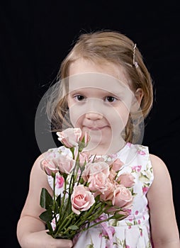 Three year old girl with roses