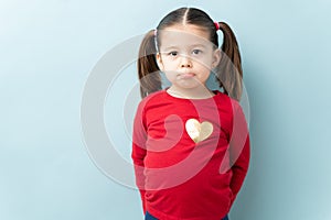 Three year old pouting in a studio
