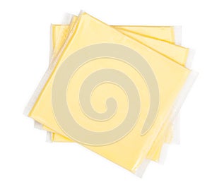 Three yellow cheese slices packaged on white background. Close-up, top view