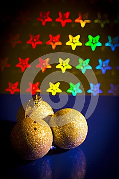 Three yellow Christmas balls on stars background of bright color