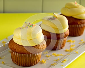 Three Yellow Cupcakes with Lemon Frosting