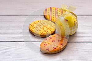 Three yellow easter cookies with a chik on the right photo