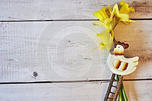 Three yellow jonquils with traditional Easter decoration