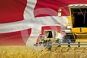 Three yellow modern combine harvesters with Denmark flag on rye field - close view, farming concept - industrial 3D illustration