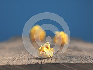 Three yellow paper balls on a table