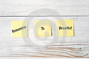 Three Yellow Post It notes with Message Remember to Breathe!