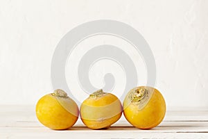 Three yellow raw organic turnips on the white background