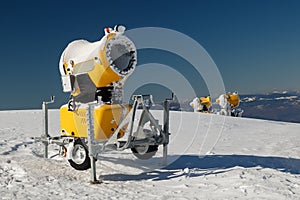 Three yellow snow guns