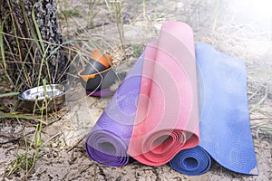 Three yoga mats on the sandy beach of the forest, situated near