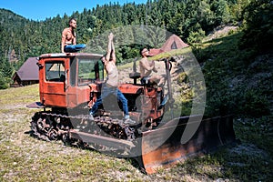 Three yogi men on the old Bulldozer