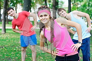 Three young adults exercising outdoors