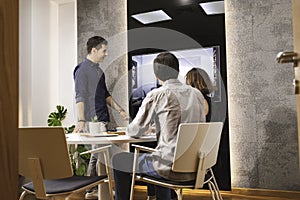 Closeup of young architects discussing together inside a conference room