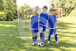 Three, Young boy with soccer ball on a sport uniform