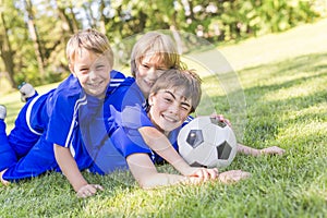 Three, Young boy with soccer ball on a sport uniform