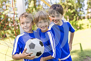 Three, Young boy with soccer ball on a sport uniform