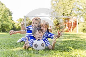 Three, Young boy with soccer ball on a sport uniform