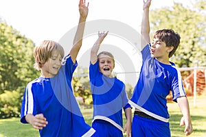 Three, Young boy with soccer ball on a sport uniform