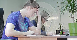 Three Young Business People Using Computer in the Office. Two Decorator`s Colleagues Working Together on an Innovative