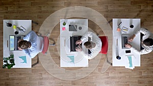 Three young businessman come to workplace with coffee simultaneously, work concept, office concept, communication