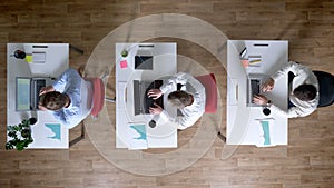 Three young businessman are working on laptops, leaving workplace simultaneously, work concept, office concept