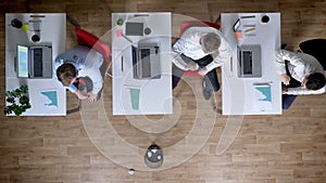 Three young businessman on workplace play on paper toss, rest concept, office concept, top shot