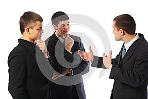 Three young businessmen talk