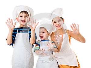 Three young chefs with hands in flour