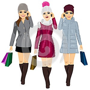 Three young fashion women with shopping bags