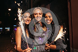 Three young female friends enjoying new years eve