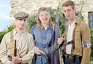 three young French Resistance, vintage clothes and weapons, reenactment