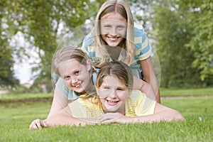 Three young girl friends piled on each photo