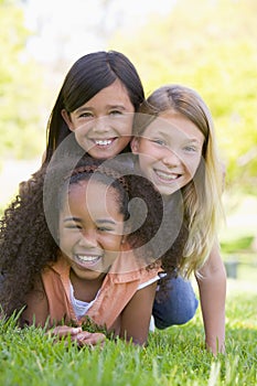 Three young girl friends piled up