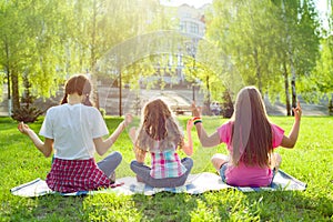 Three young girls doing yoga