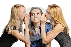 Three young girls gossiping