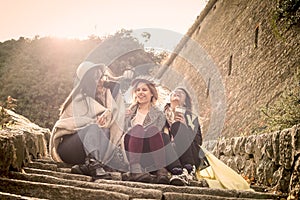 Three young girls sitting on the stairs.