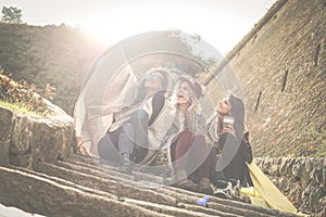 Three young girls sitting on the stairs.