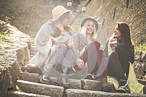 Three young girls sitting on the stairs.