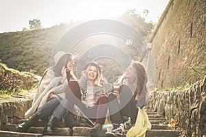 Three young girls sitting on the stairs at the public park. Three young girls sitting on the stairs at the public park an having